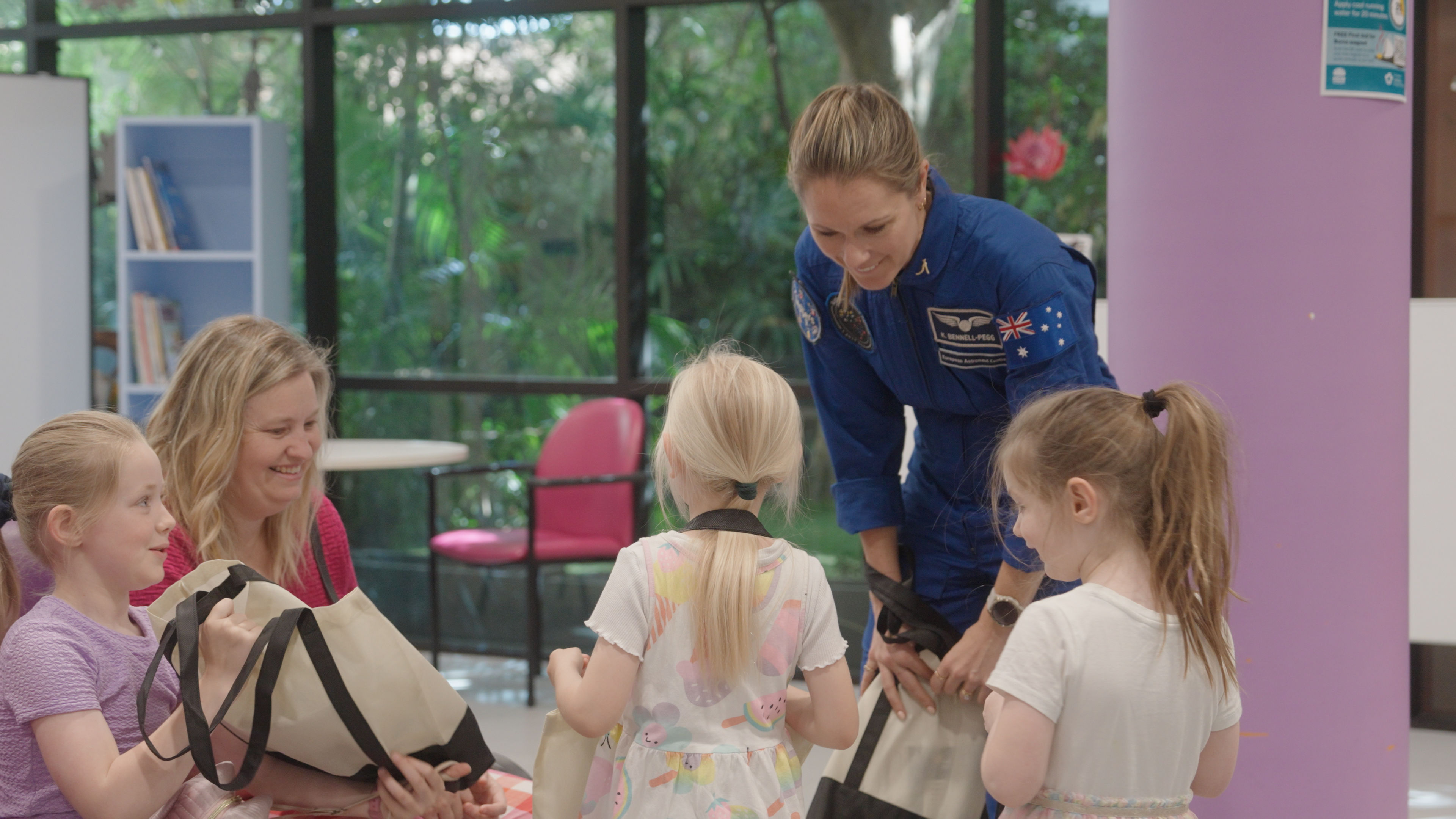 Image of astronaut with children smiling. Image of astronaut with children smiling.