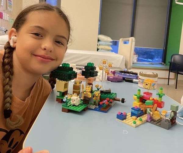 Tayla with her Lego collection in hospital