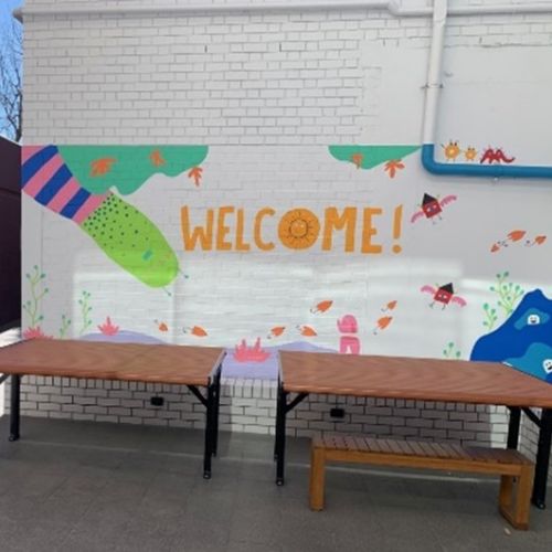 A wall painting at Sunny's Courtyard with animals and the word 'Welcome!'