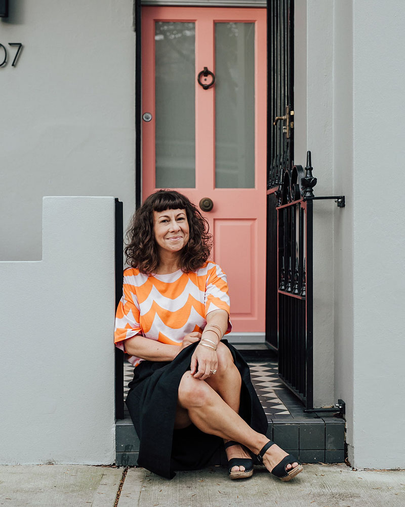 Beck sitting in front of her apartment