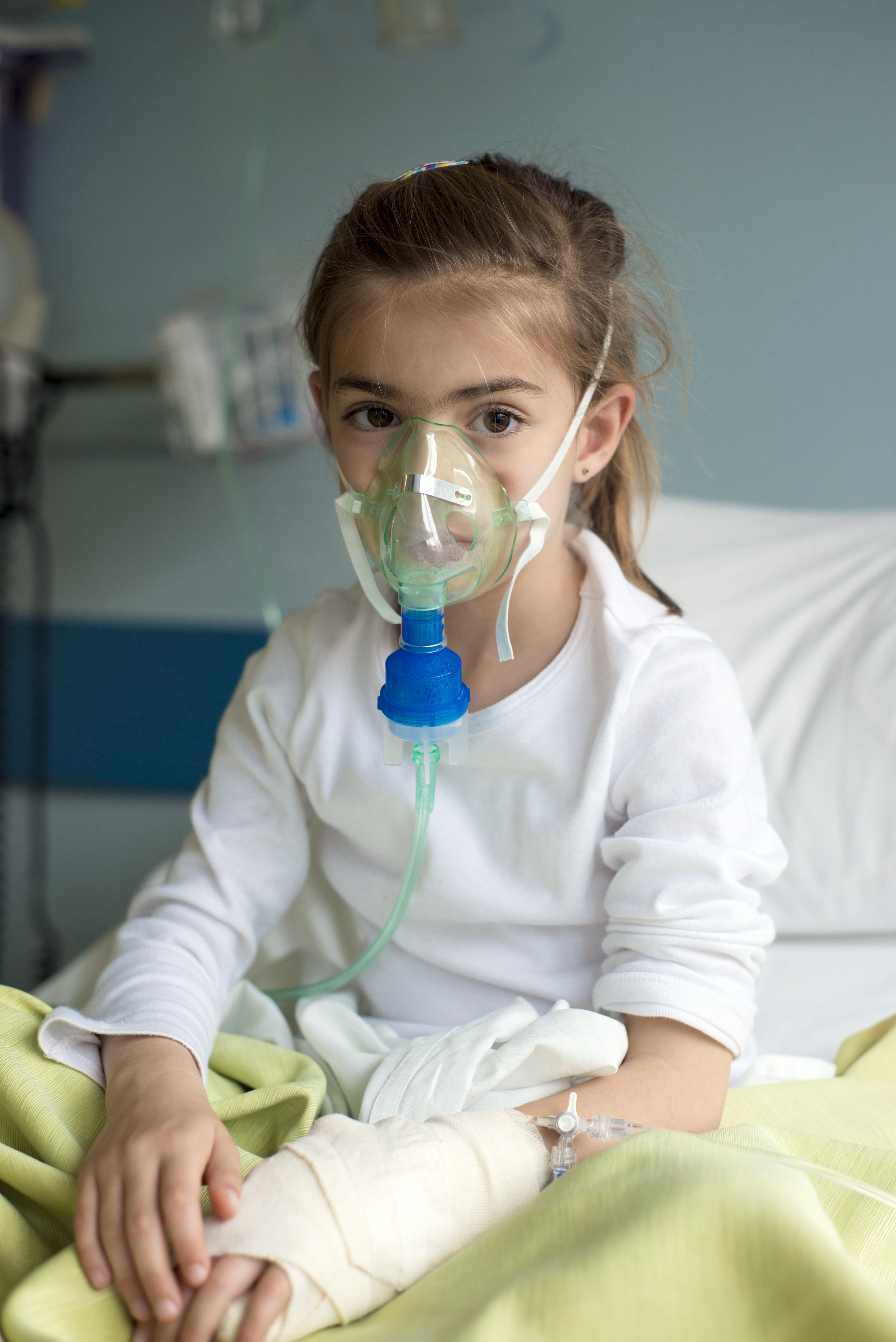 young girl in hospital with a nebuliser on