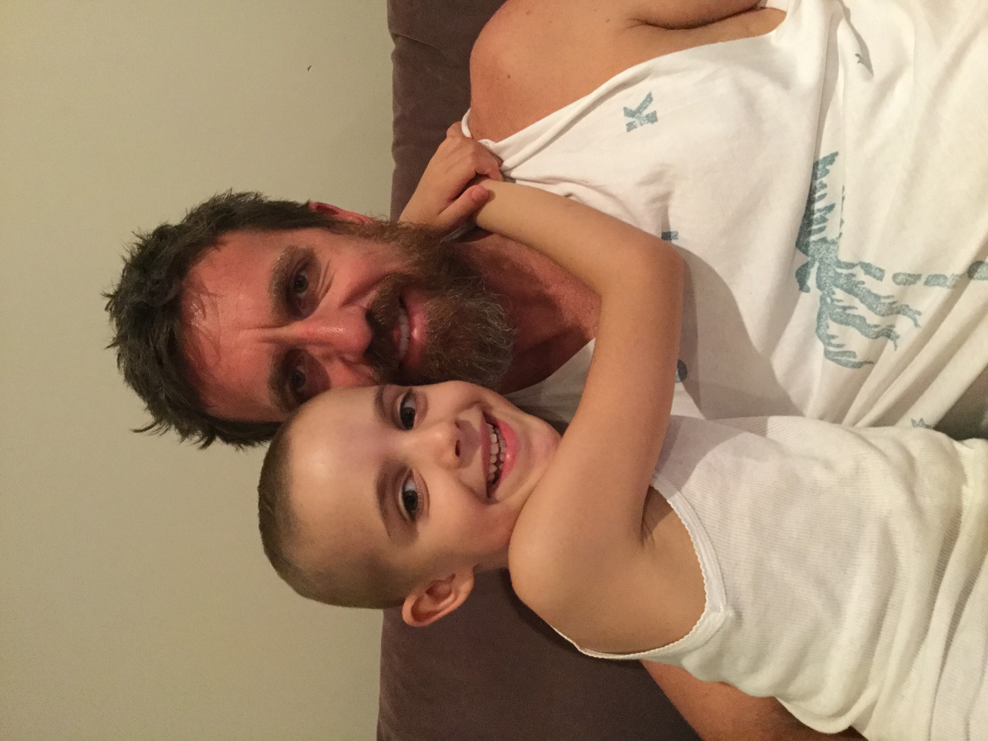 Kyla with her arms around her dad's neck giving him a hug