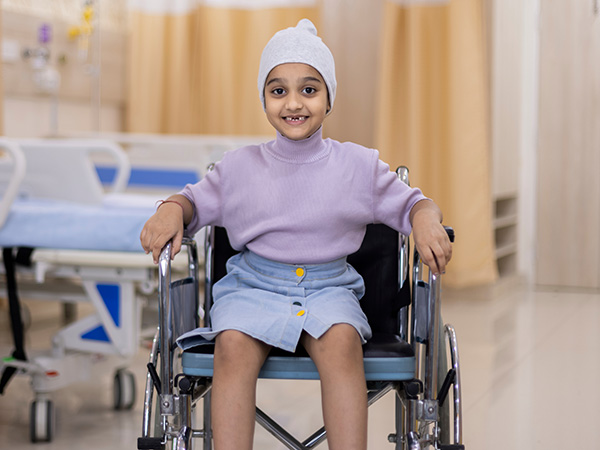 A young girl in a wheelchair in a hospital setting