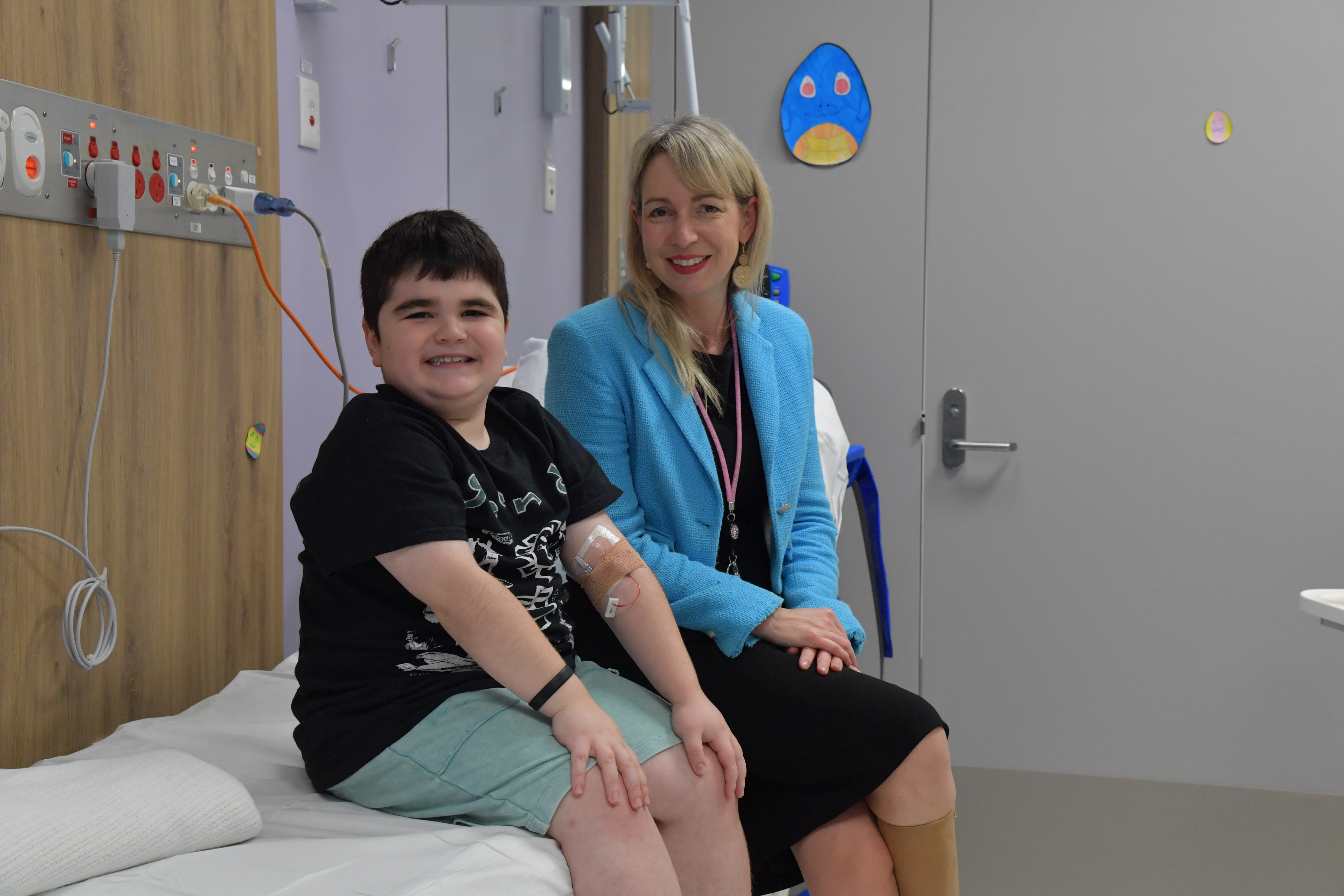 image of child sitting on a hospital bed image of child sitting on a hospital bed