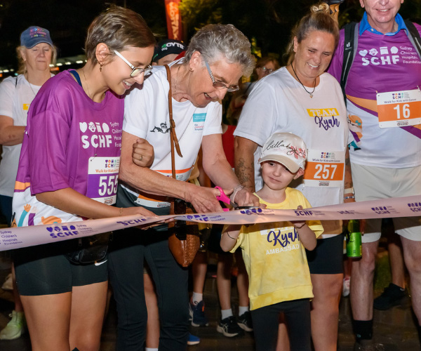 Pictured from left to right: Mia, Carol and Kyah cut the ribbon to mark the official start of Walk for Kids with Cancer 2023