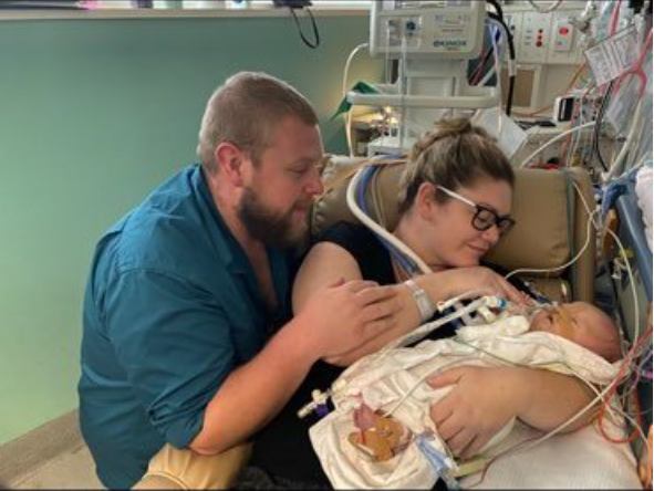 Attlee and her parents, Georgha and Kodi, in hospital