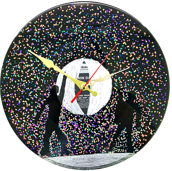 Vinyl record drawn over to create two dancing silhouettes with hundreds of colourful dots around them. In the centre of the record are the hands of a clock pointing in three different directions