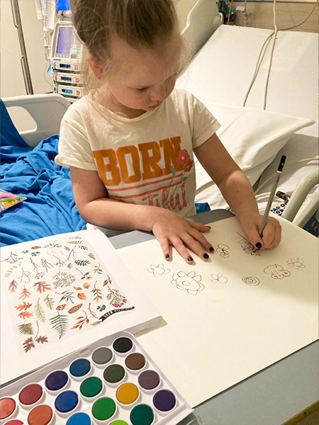 Chelsea drawing flowers and butterflies in hospital