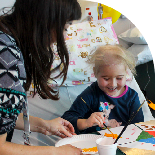 A young child painting in hospital