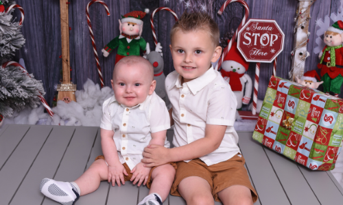 Ashton and his brother posing for a Christmas photo