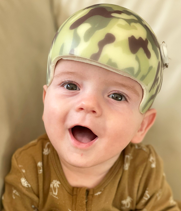 Reuben wearing a green camouflaged pattern helmet