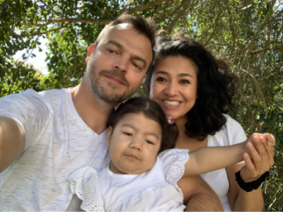 Lucia cuddling her parents Karla and Johann