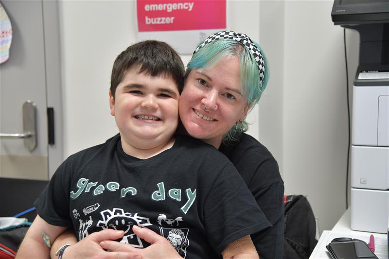 Image of child sitting with his mum in clinical room in hospital. Image of child sitting with his mum in clinical room in hospital.