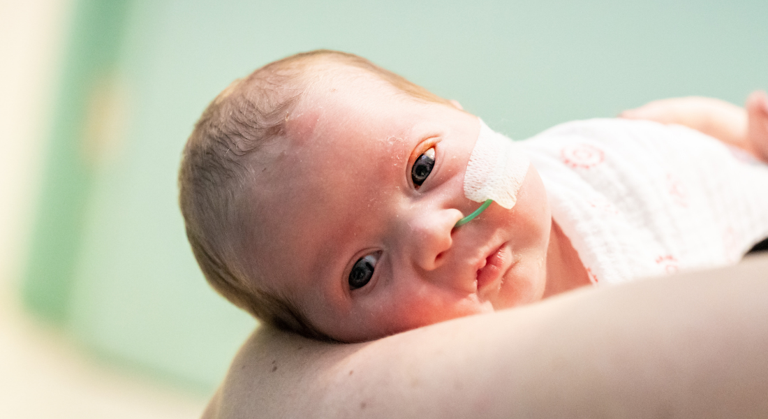 Newborn Everleigh being held by her mum