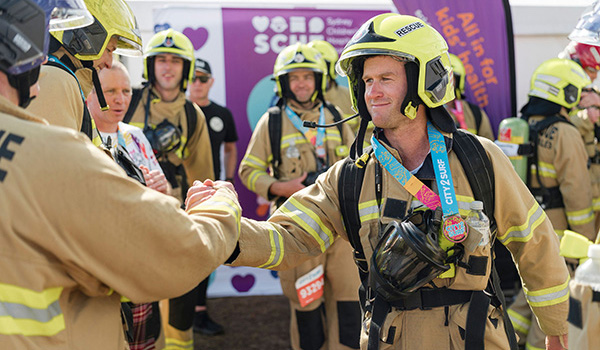 Two firemen shaking hands after completing City2Surf for team SCHF Two firemen shaking hands after completing City2Surf for team SCHF