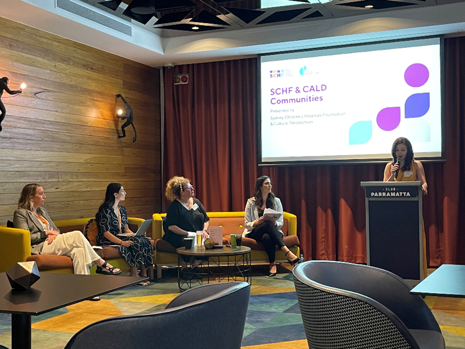 A group of people watching a presentation