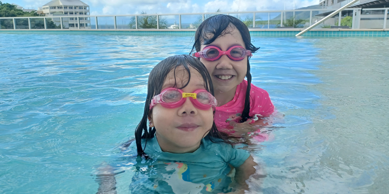 Maddy and Briella swimming in a pool