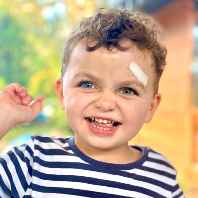 Noah playing outside with a striped shirt on. he has a cheeky grin on his face as he pokes his tongue out Noah playing outside with a striped shirt on. he has a cheeky grin on his face as he pokes his tongue out