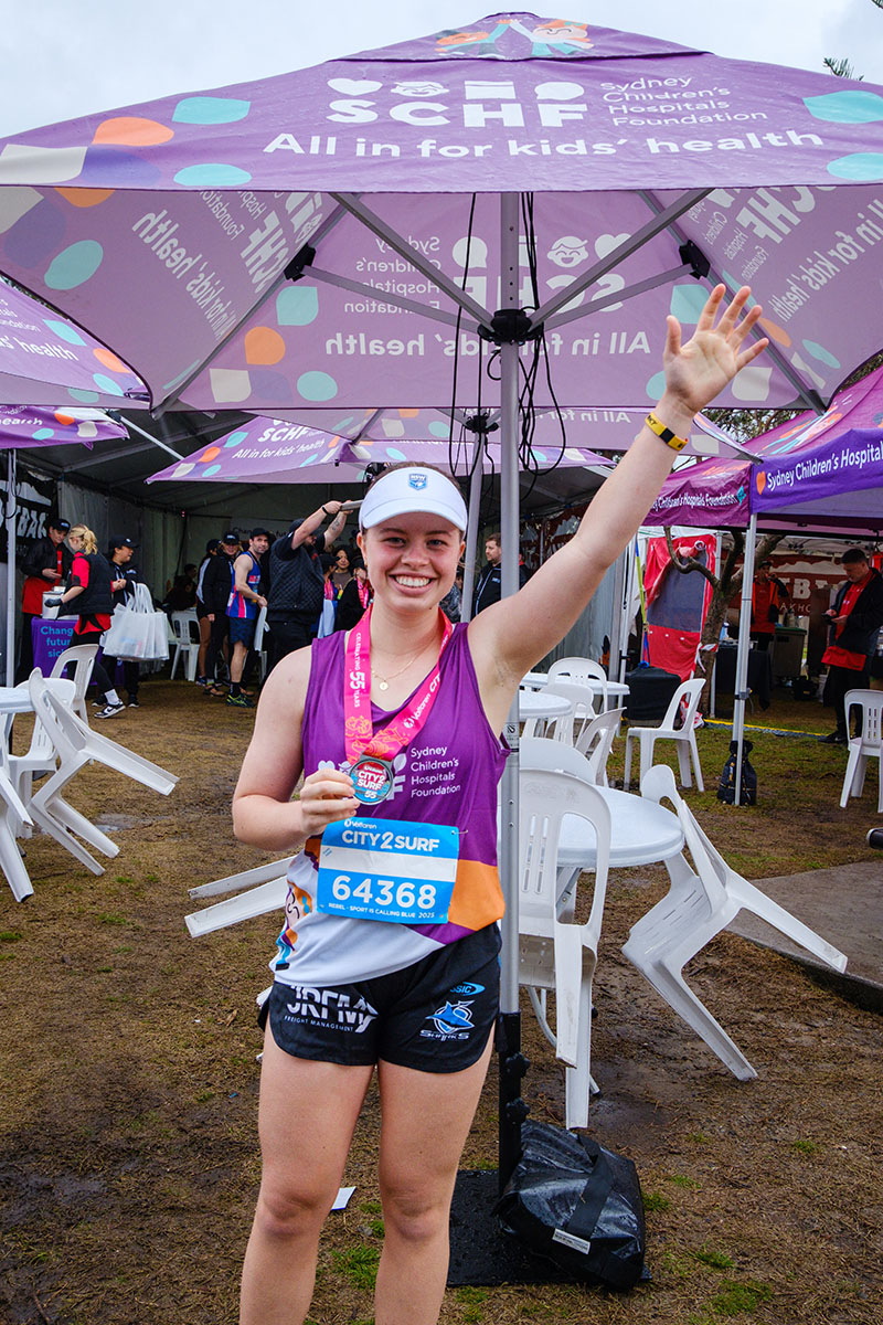 Emily holding her medal at City2Surf