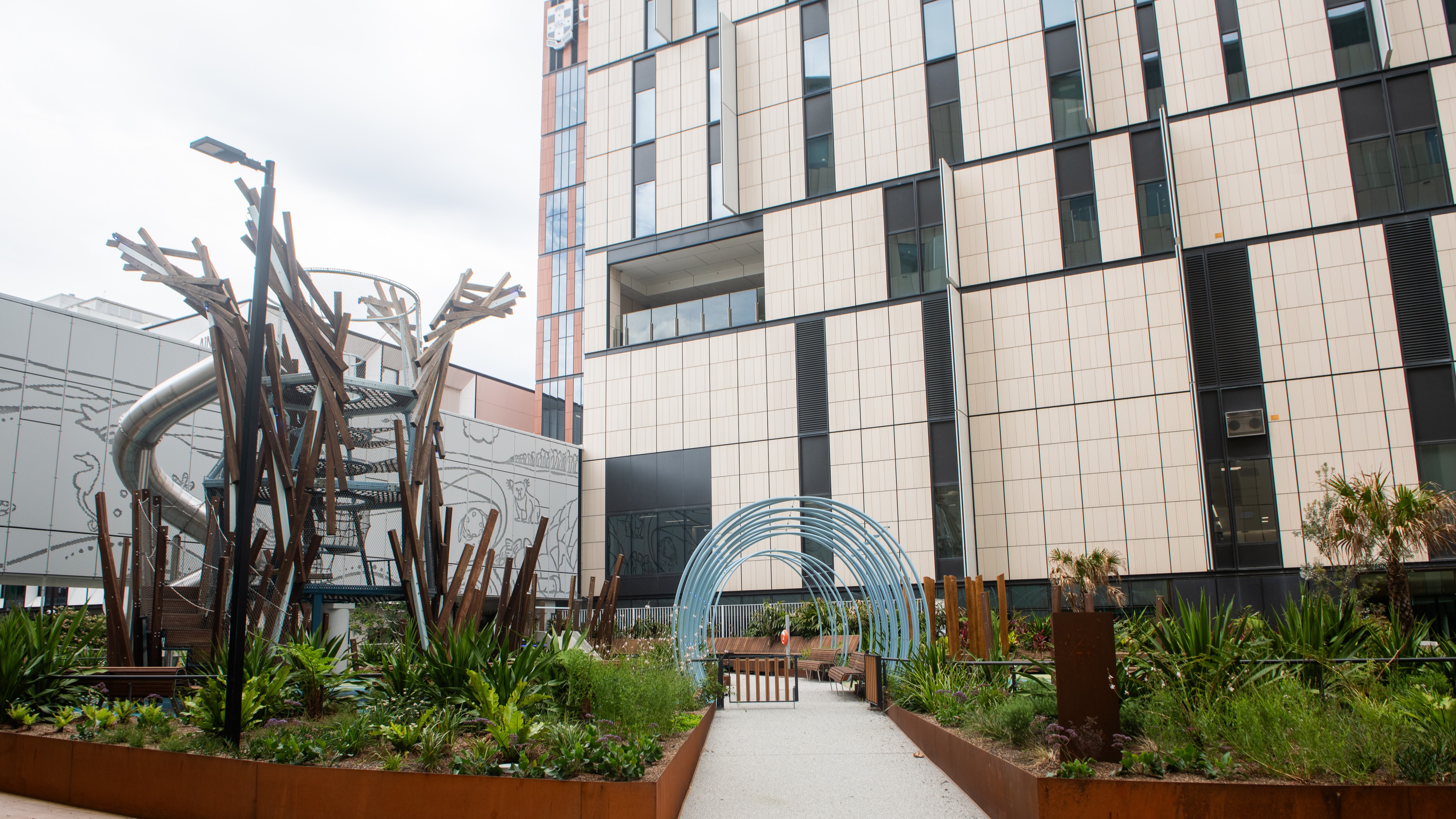 Playground with greenery, metal arches, and climbing structures at Sydney Children’s Hospital, Randwick.