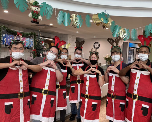 The staff at Sunny's cafe dressed in Santa aprons and reindeer hats